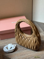 Wrist bag with wrinkled crescent shape