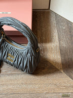 Wrist bag with wrinkled crescent shape
