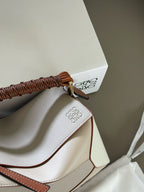 Woven handle, color blocked geometric bag, cowhide