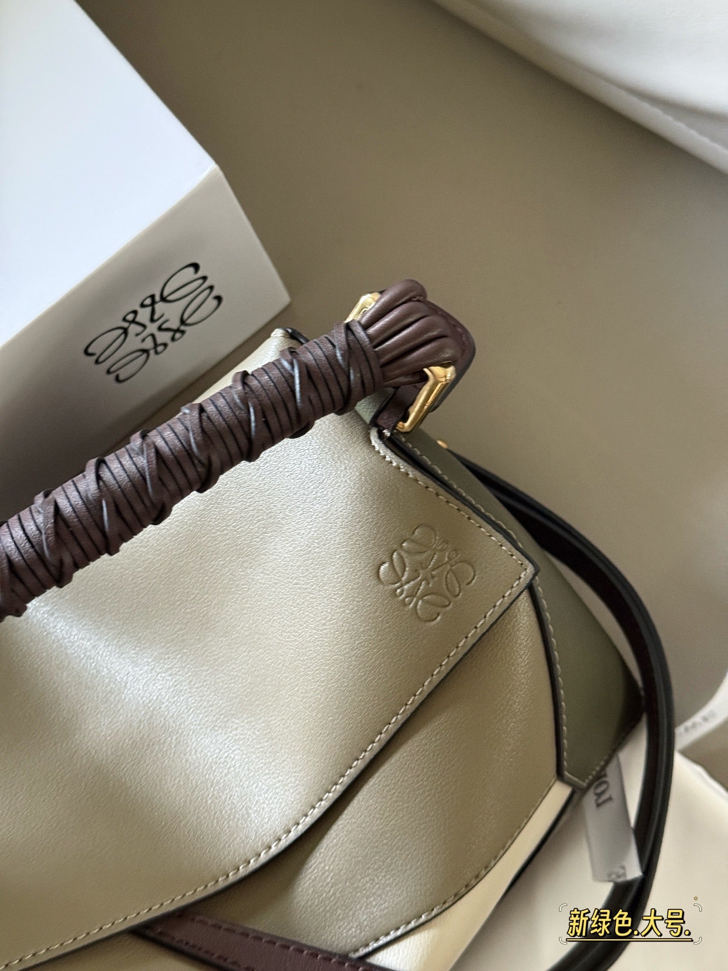 Woven handle, color blocked geometric bag, cowhide
