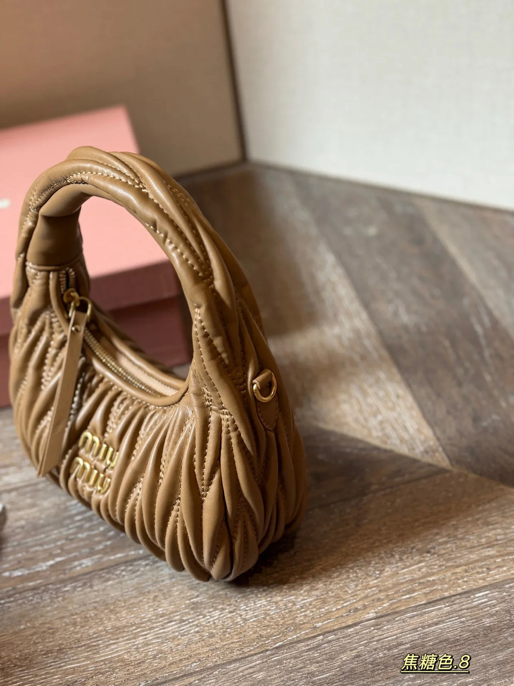 Wrist bag with wrinkled crescent shape