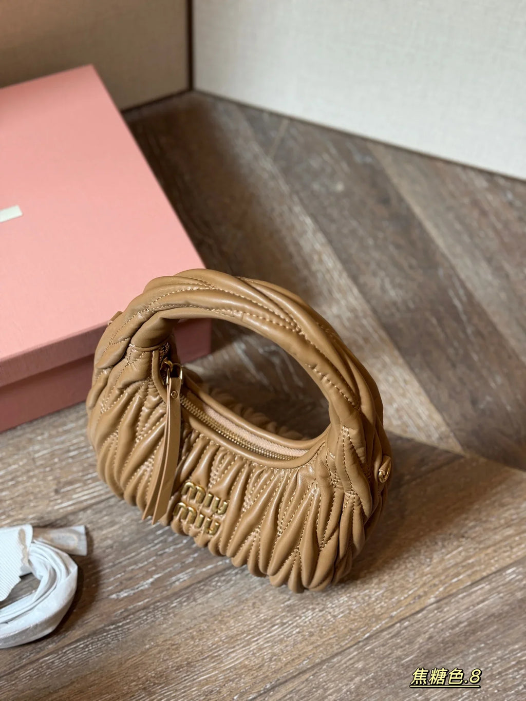 Wrist bag with wrinkled crescent shape