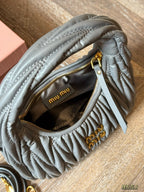 Wrist bag with wrinkled crescent shape