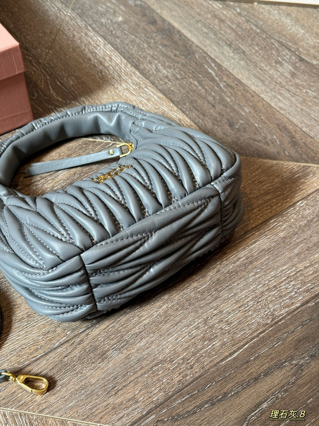 Wrist bag with wrinkled crescent shape