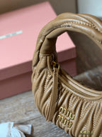 Wrist bag with wrinkled crescent shape
