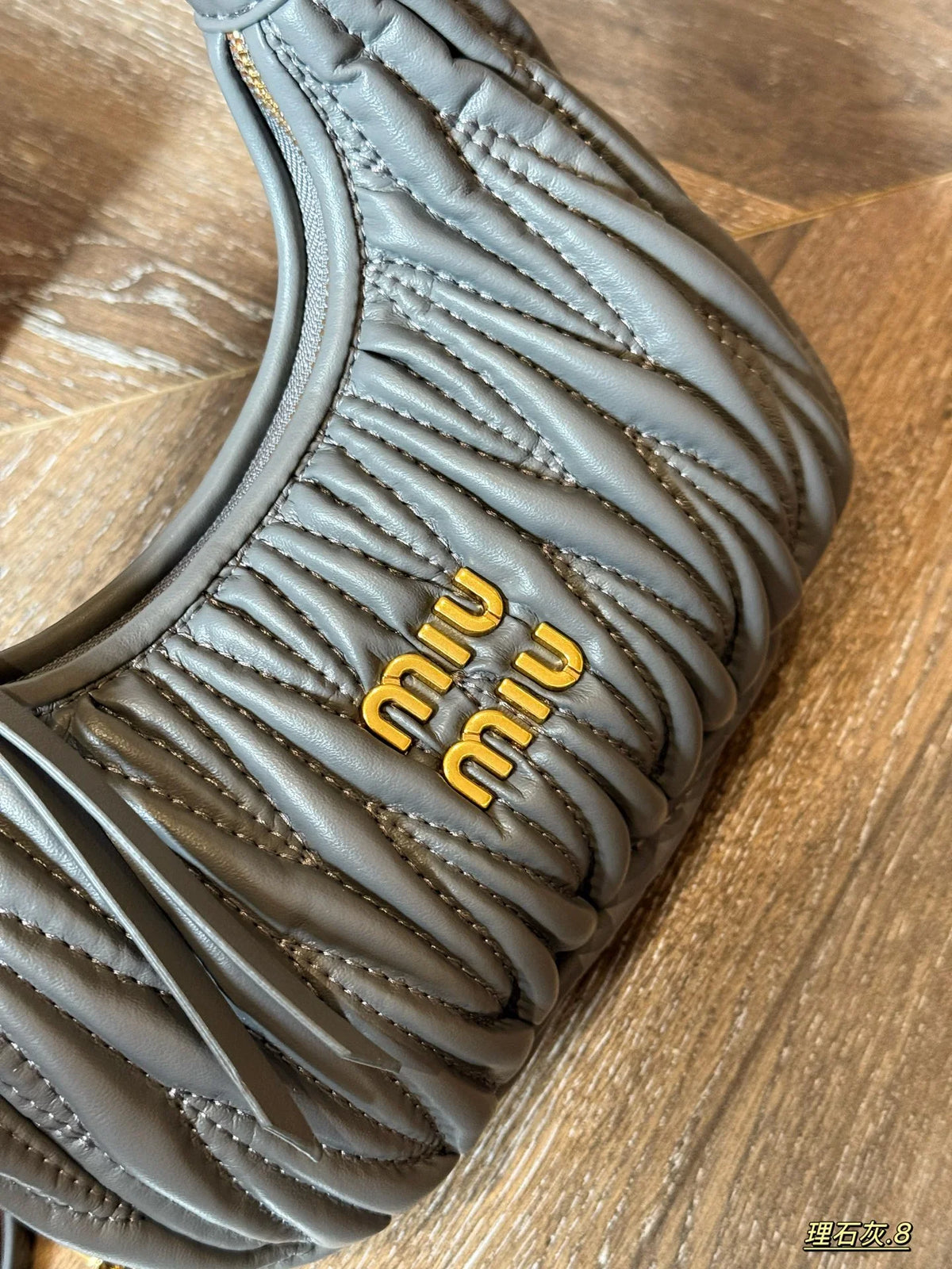 Wrist bag with wrinkled crescent shape