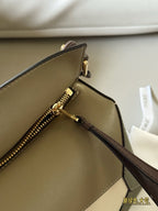 Woven handle, color blocked geometric bag, cowhide